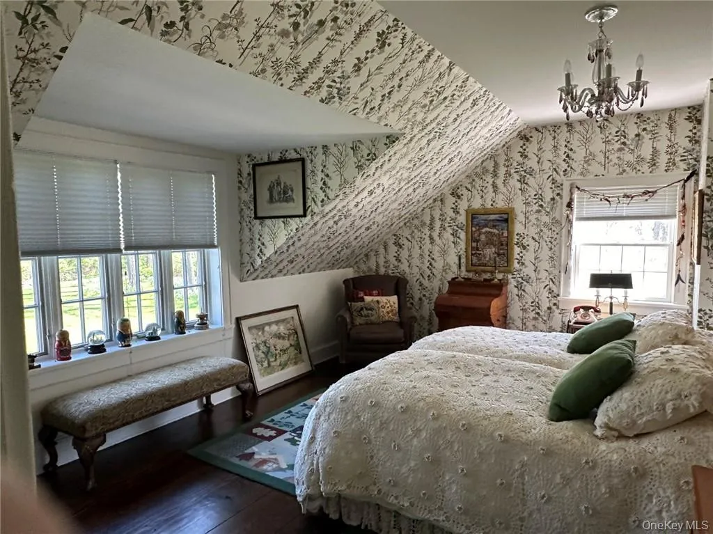 Bedroom with hardwood / wood-style floors, a chandelier, and multiple windows Bedroom with hardwood / wood-style floors, a chandelier, and multiple windows