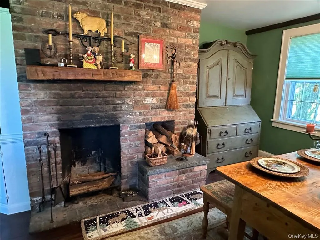 Dining space featuring brick fireplace, and crown molding Dining space featuring brick fireplace, and crown molding