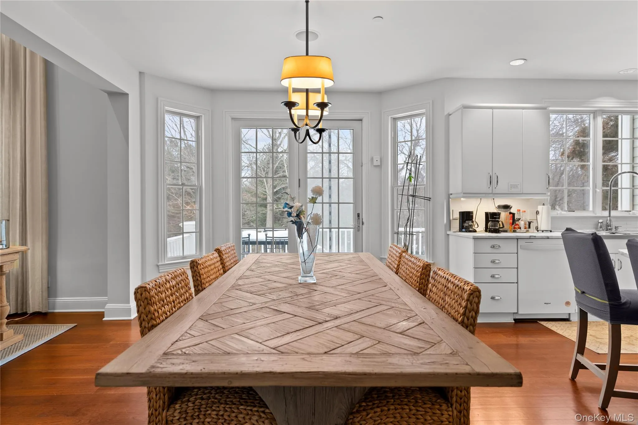 Dining space with dark wood-style floors and baseboards Dining space with dark wood-style floors and baseboards