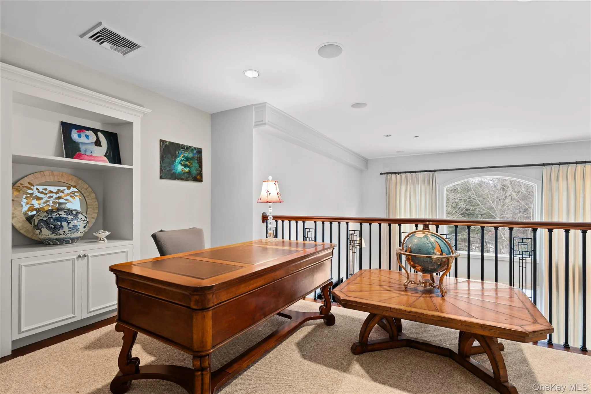 Office space featuring built in shelves and recessed lighting Office space featuring built in shelves and recessed lighting