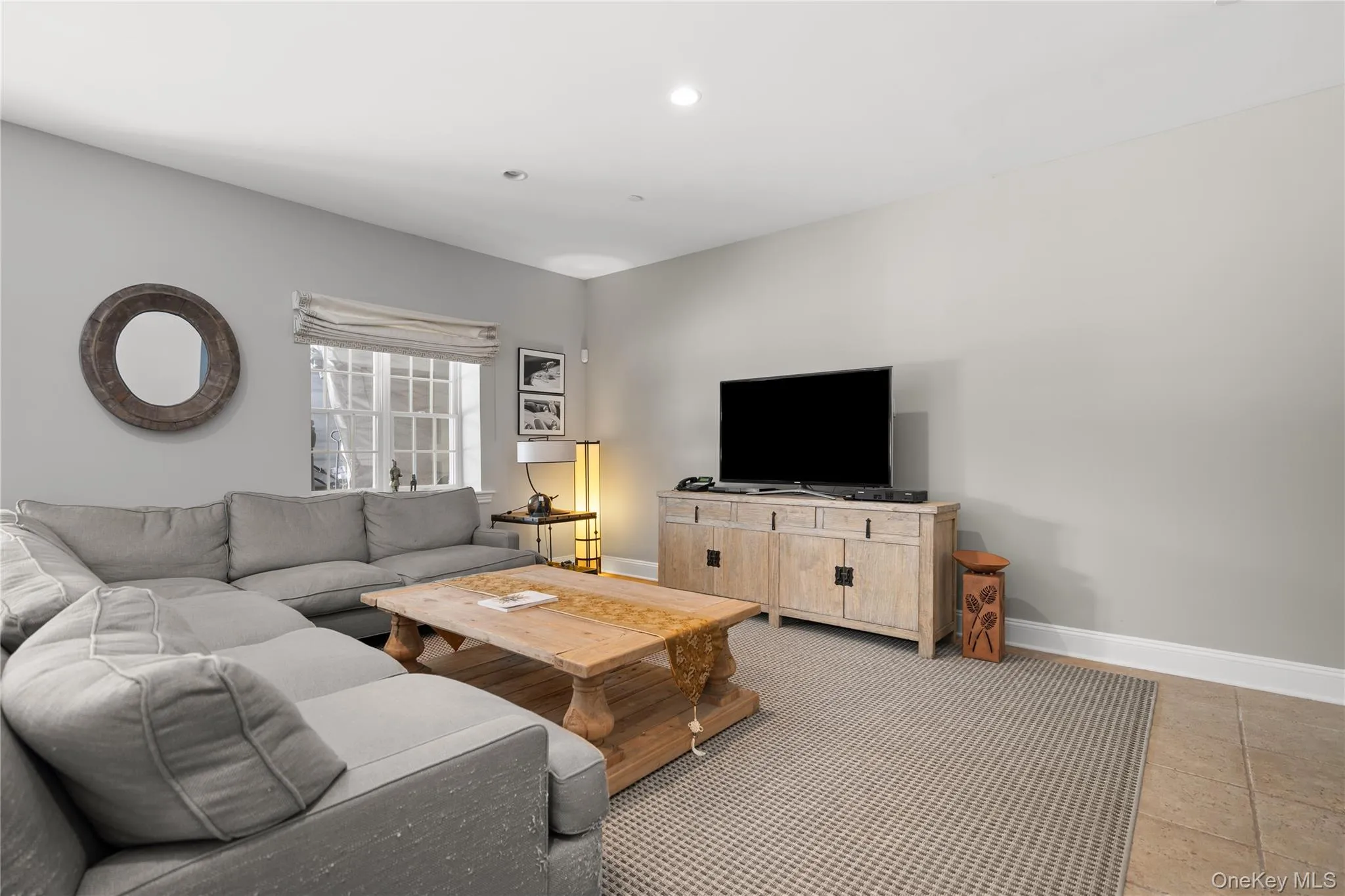 Living room featuring baseboards and recessed lighting Living room featuring baseboards and recessed lighting