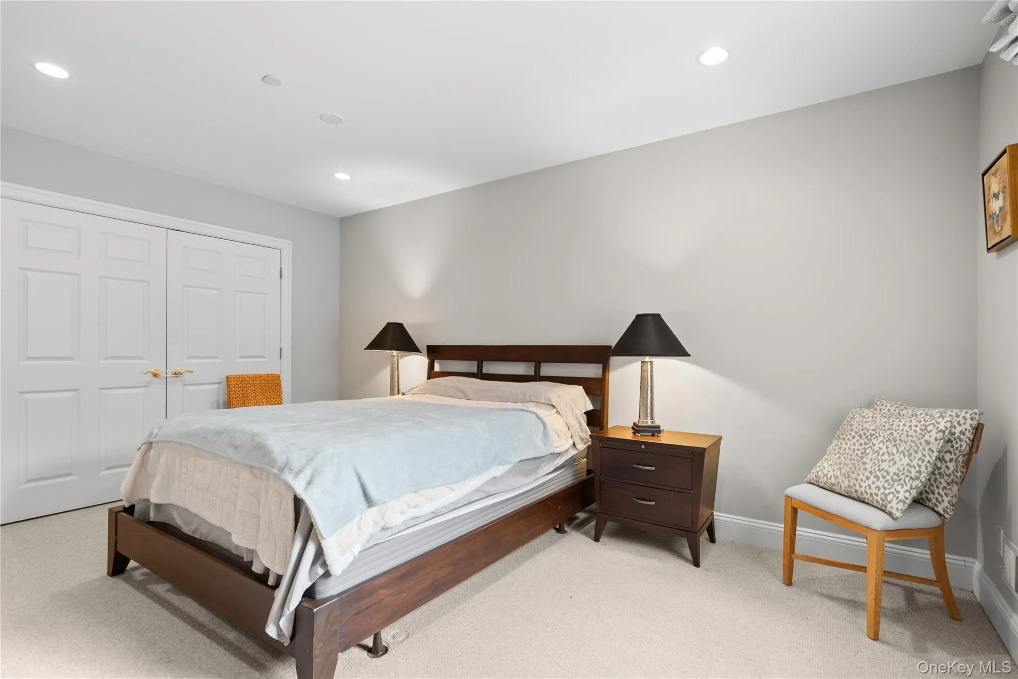 Bedroom with light colored carpet, a closet, and recessed lighting Bedroom with light colored carpet, a closet, and recessed lighting