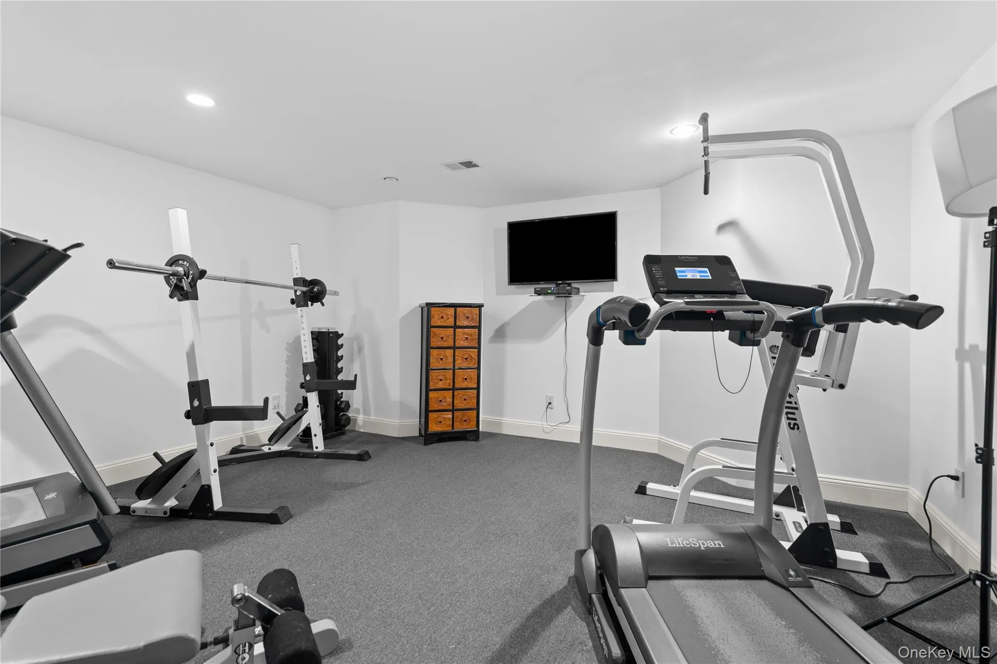 Workout room featuring baseboards and recessed lighting Workout room featuring baseboards and recessed lighting