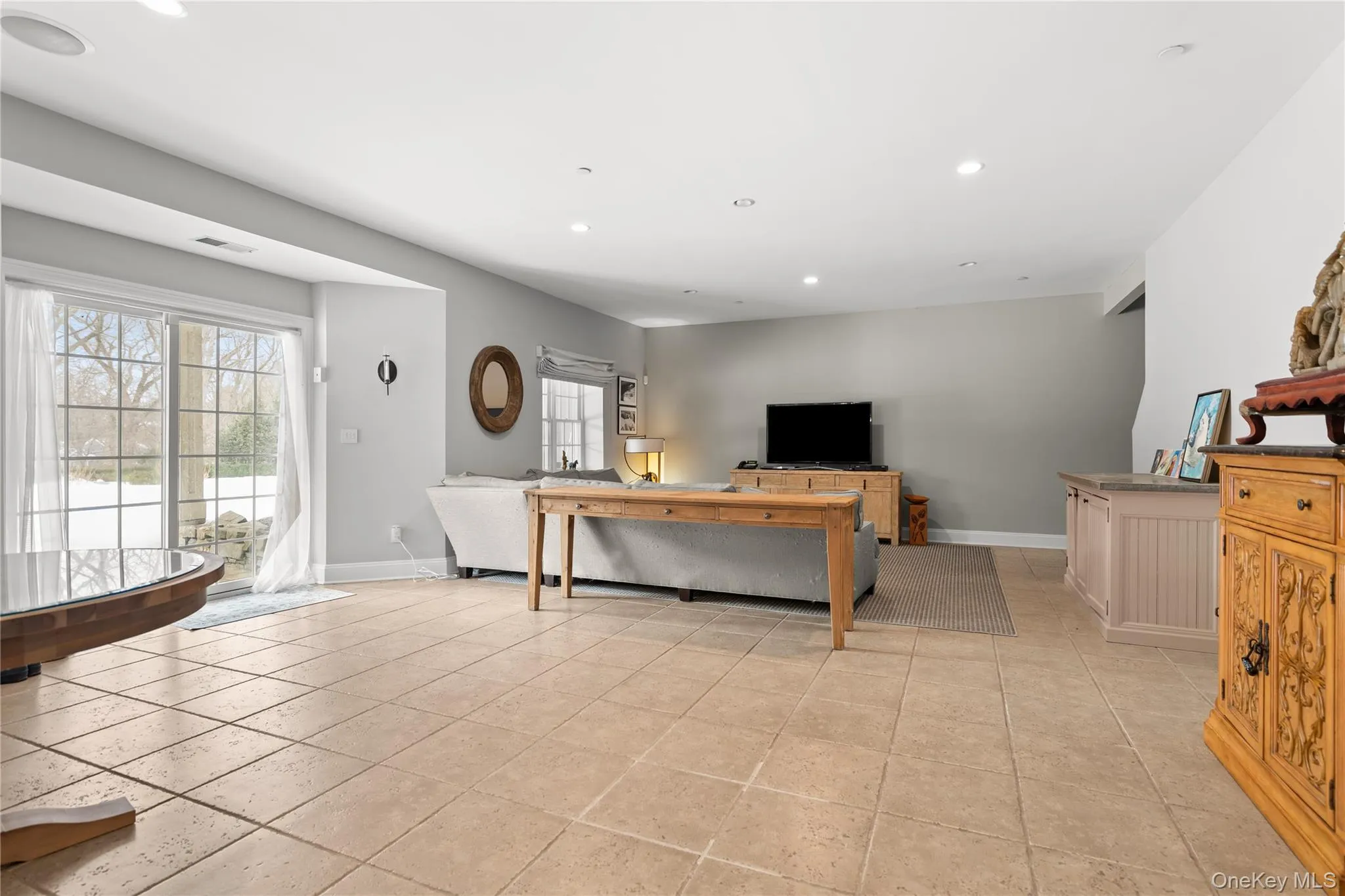 Living room with recessed lighting and light tile patterned flooring Living room with recessed lighting and light tile patterned flooring