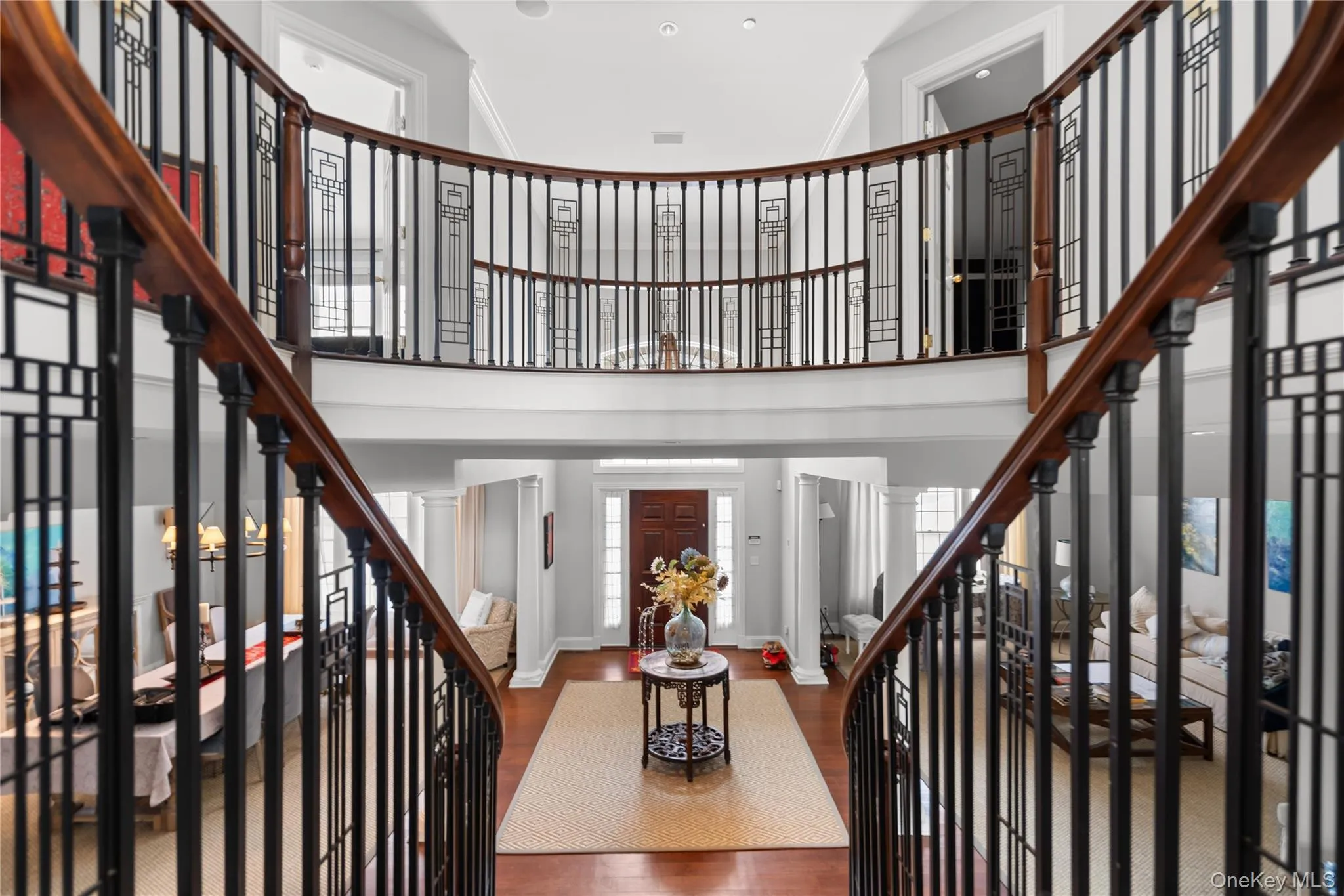 Foyer entrance featuring wood finished floors and a high ceiling Foyer entrance featuring wood finished floors and a high ceiling