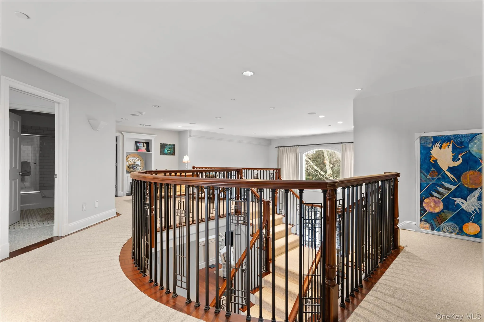Hall featuring an upstairs landing, light colored carpet, and recessed lighting Hall featuring an upstairs landing, light colored carpet, and recessed lighting