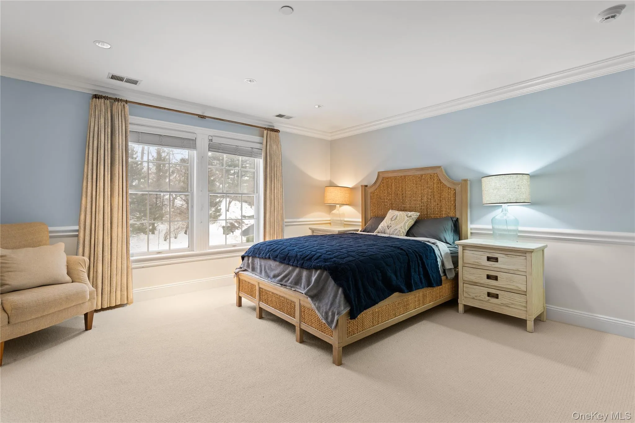 Bedroom featuring ornamental molding and light colored carpet Bedroom featuring ornamental molding and light colored carpet