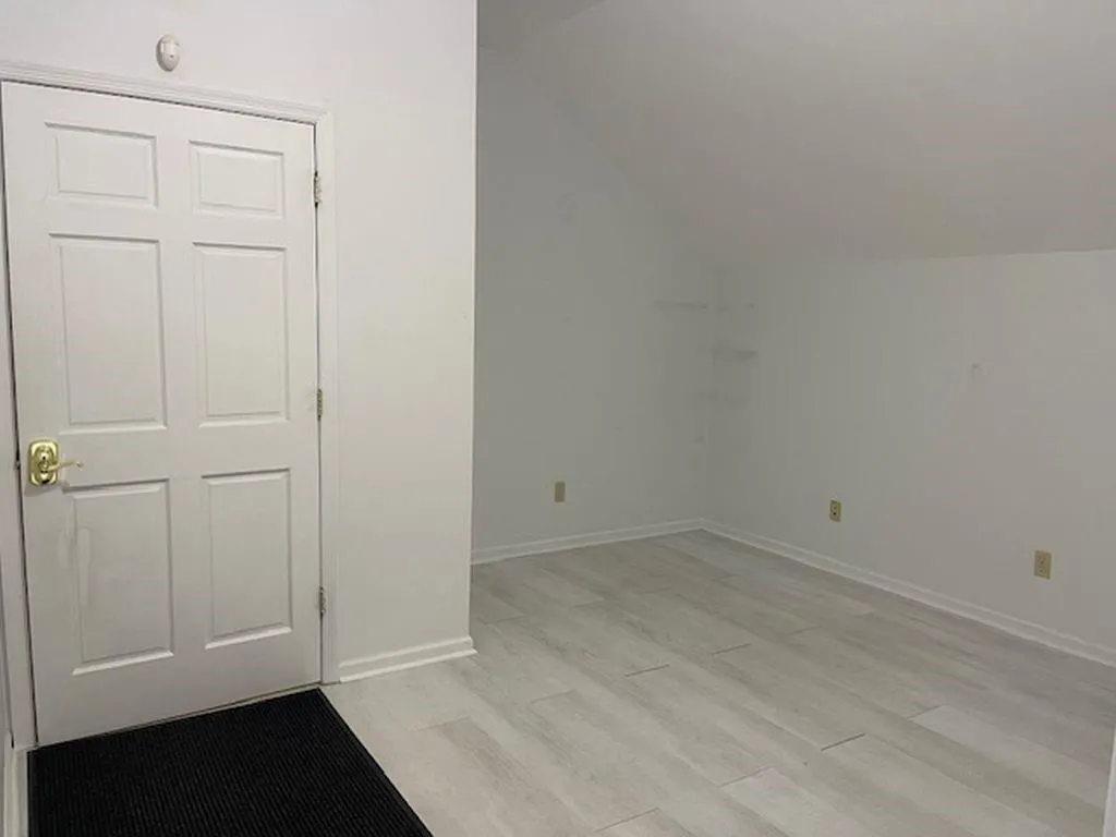 Additional living space featuring light hardwood / wood-style floors and lofted ceiling Additional living space featuring light hardwood / wood-style floors and lofted ceiling