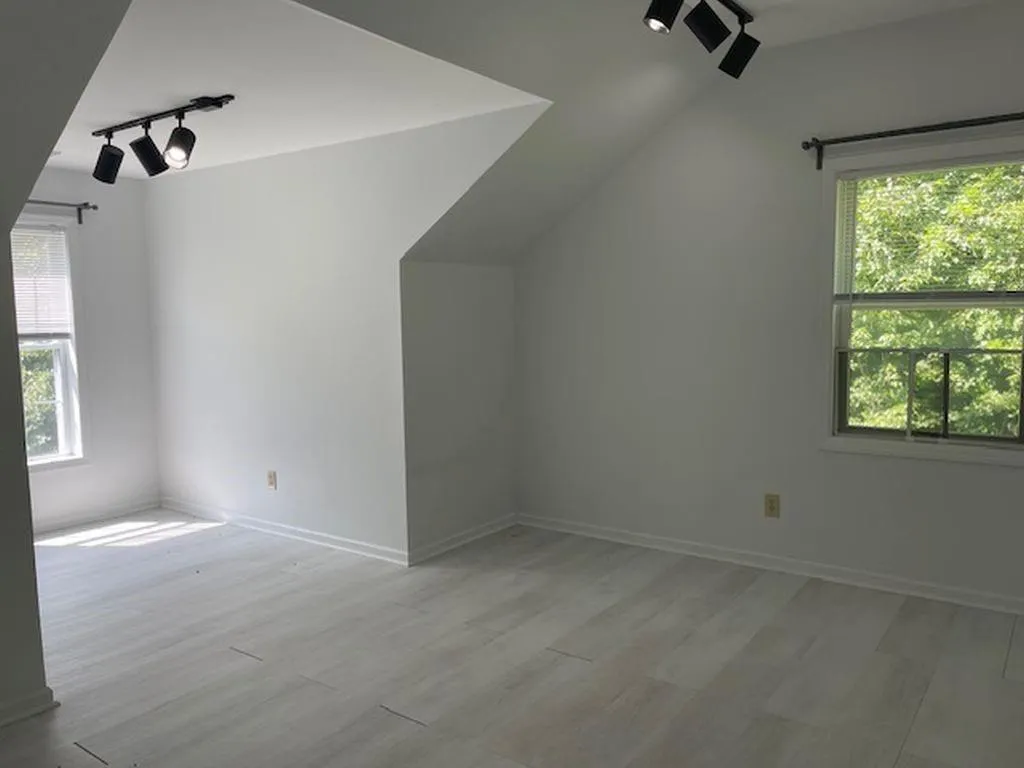 Bonus room with plenty of natural light, lofted ceiling, and wood-type flooring Bonus room with plenty of natural light, lofted ceiling, and wood-type flooring