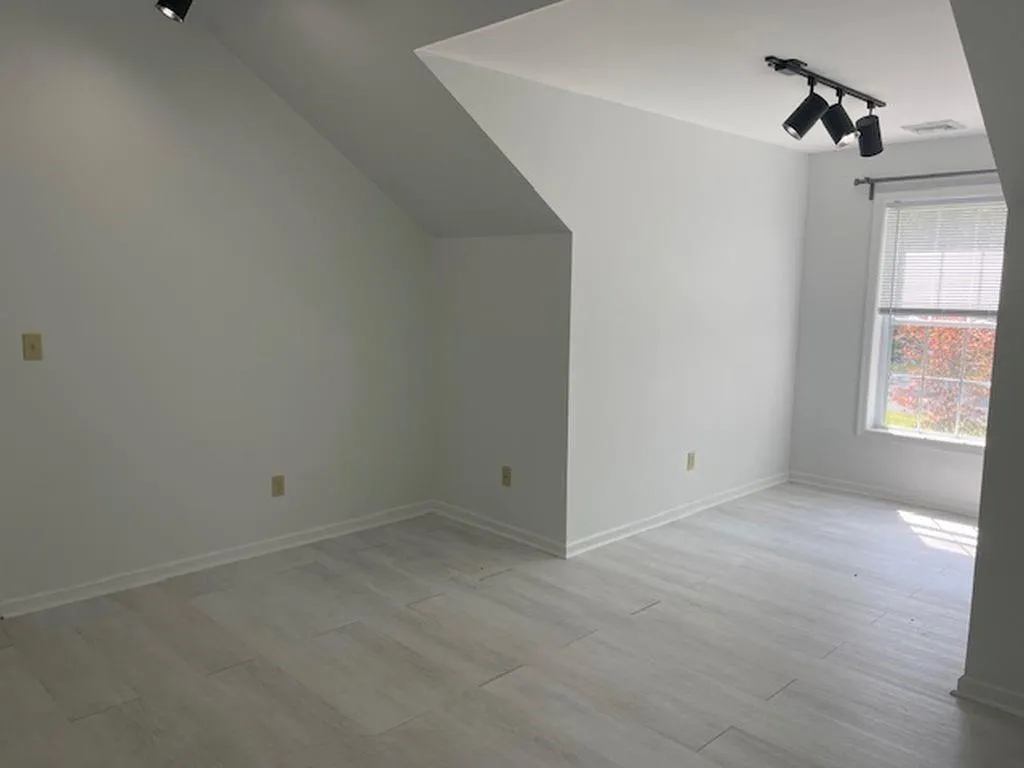 Bonus room with vaulted ceiling and light hardwood / wood-style floors Bonus room with vaulted ceiling and light hardwood / wood-style floors