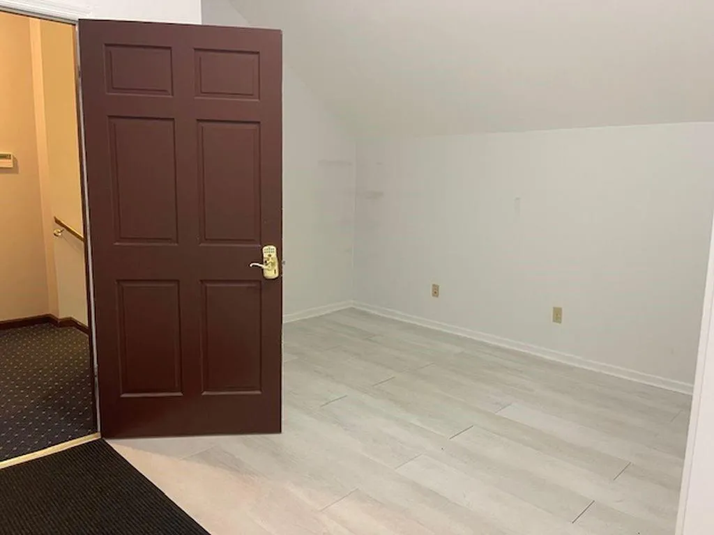 Additional living space featuring light hardwood / wood-style flooring and lofted ceiling Additional living space featuring light hardwood / wood-style flooring and lofted ceiling