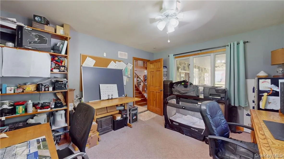 Office with ceiling fan and light colored carpet Office with ceiling fan and light colored carpet