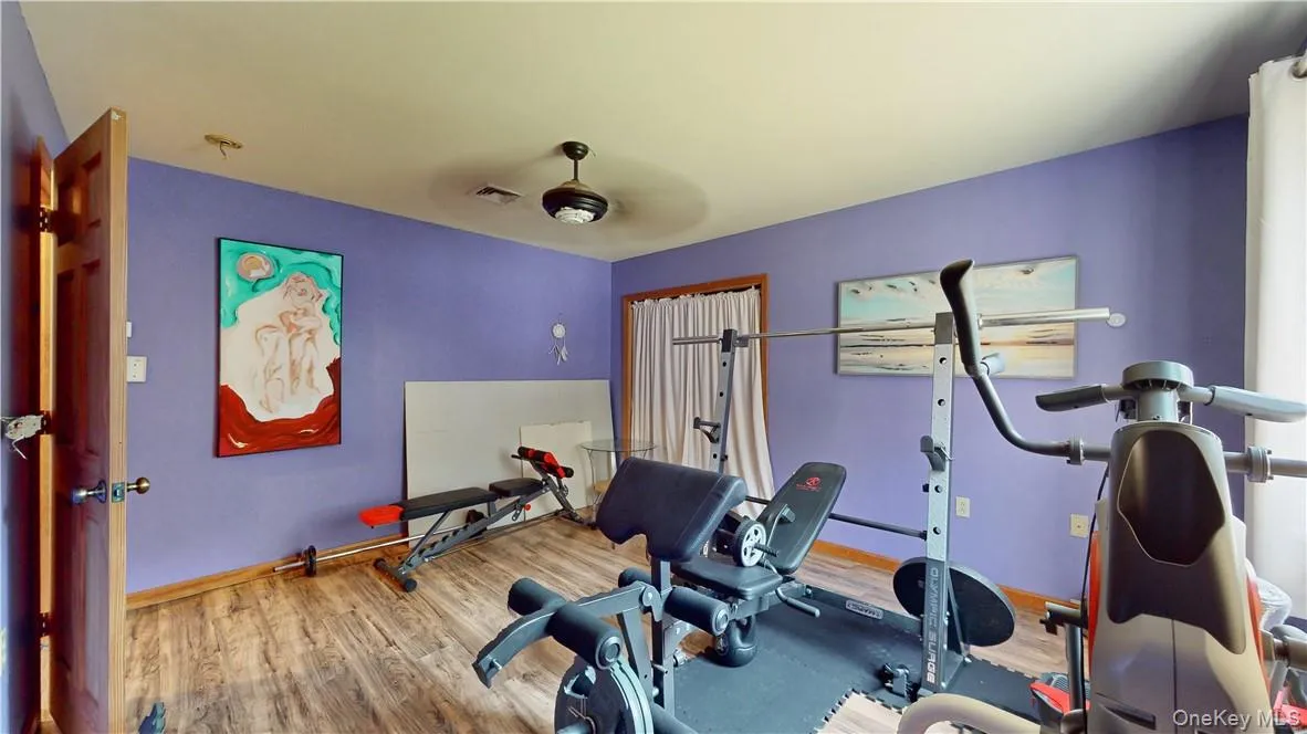 Exercise area featuring hardwood / wood-style floors and ceiling fan Exercise area featuring hardwood / wood-style floors and ceiling fan