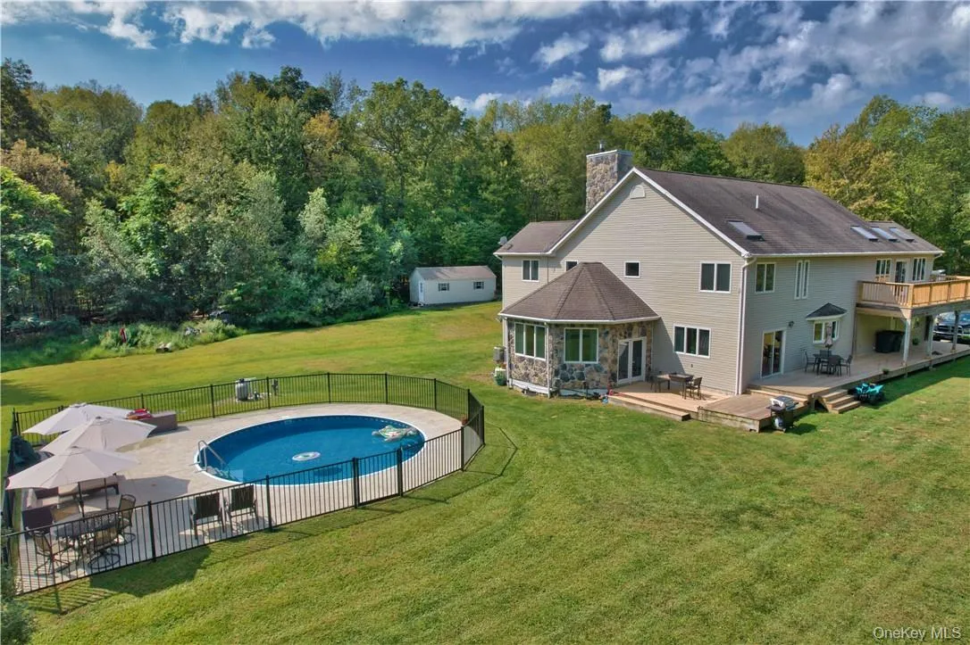 View of swimming pool featuring a yard and a patio View of swimming pool featuring a yard and a patio