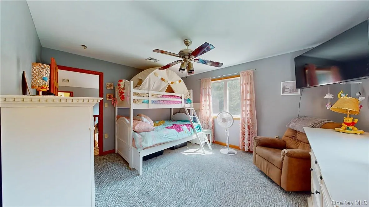 Carpeted bedroom with ceiling fan Carpeted bedroom with ceiling fan
