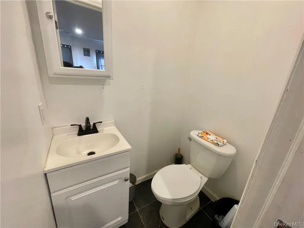 Bathroom with tile patterned floors, toilet, and vanity Bathroom with tile patterned floors, toilet, and vanity
