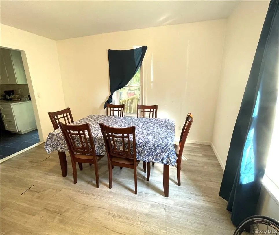 Dining room featuring wood-type flooring Dining room featuring wood-type flooring