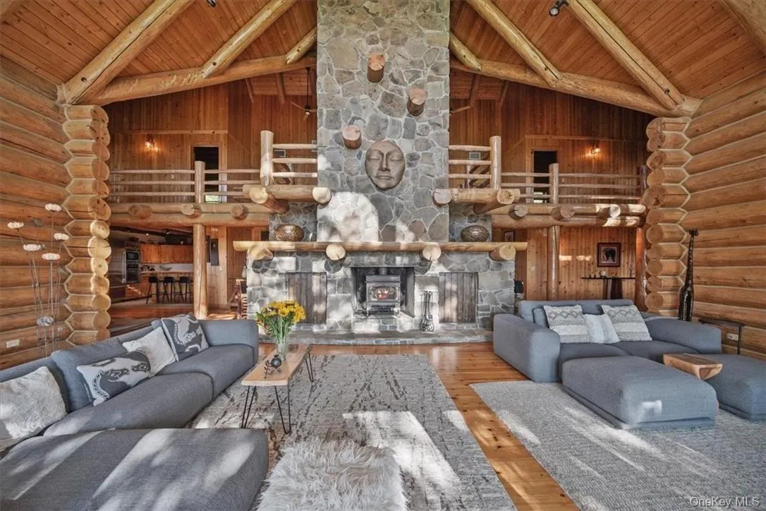 The great room's massive stone fireplace with lots of room for family and guests to relax and enjoy this retreat The great room's massive stone fireplace with lots of room for family and guests to relax and enjoy this retreat