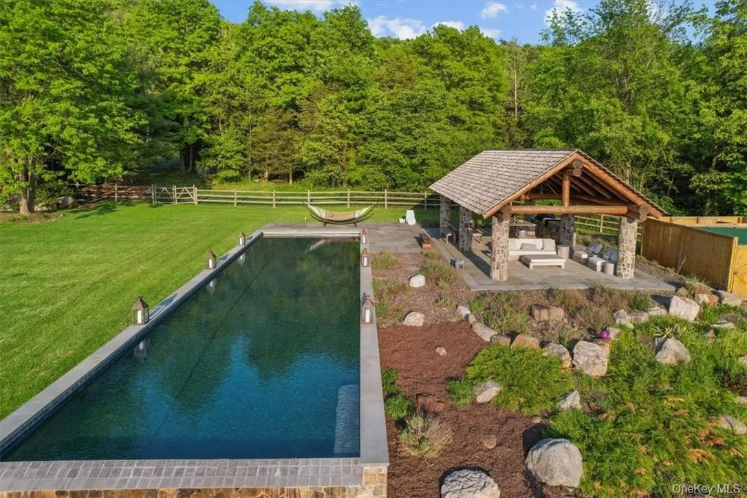 Dynamic entertaining pavilion and gorgeous 65 x 20 gunite infinity pool with waterfall Dynamic entertaining pavilion and gorgeous 65 x 20 gunite infinity pool with waterfall