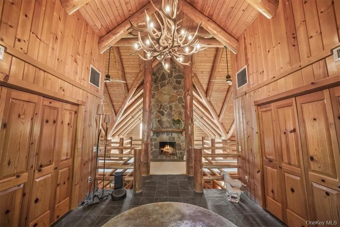Entrance with stone woodburning fireplace, cathedral ceilings and closets set the stage for the home. You are in for something very special! Entrance with stone woodburning fireplace, cathedral ceilings and closets set the stage for the home. You are in for something very special!