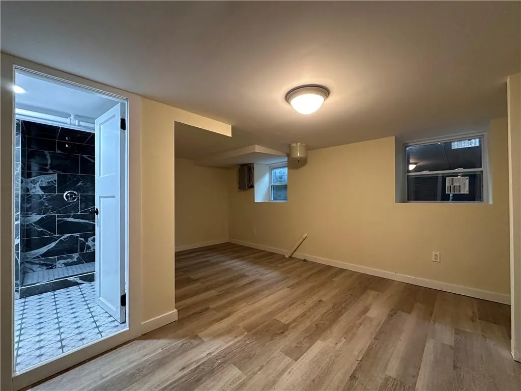 Basement featuring hardwood / wood-style flooring Basement featuring hardwood / wood-style flooring