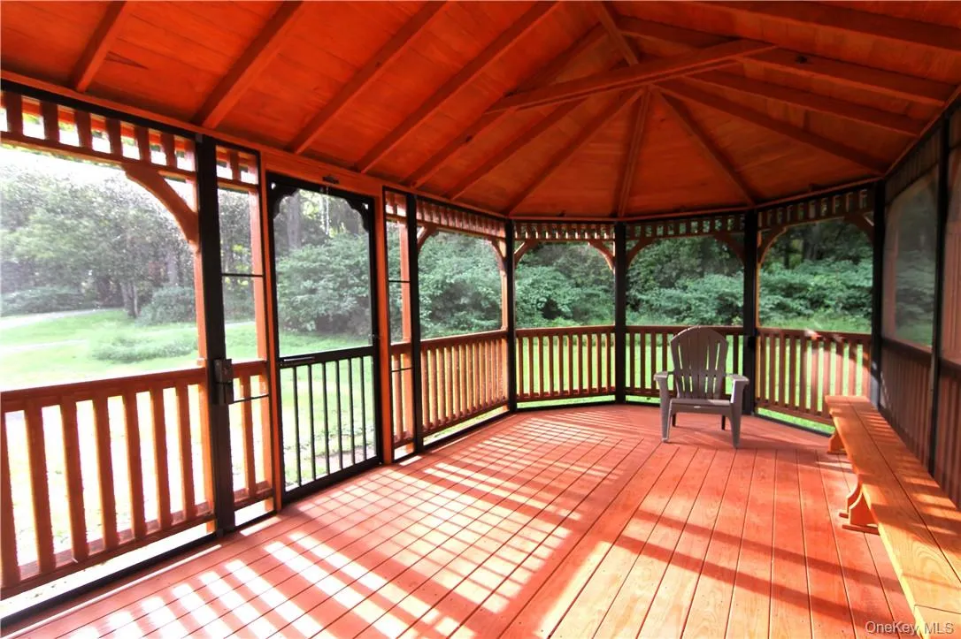 Unfurnished sunroom featuring vaulted ceiling with beams and wooden ceiling Unfurnished sunroom featuring vaulted ceiling with beams and wooden ceiling