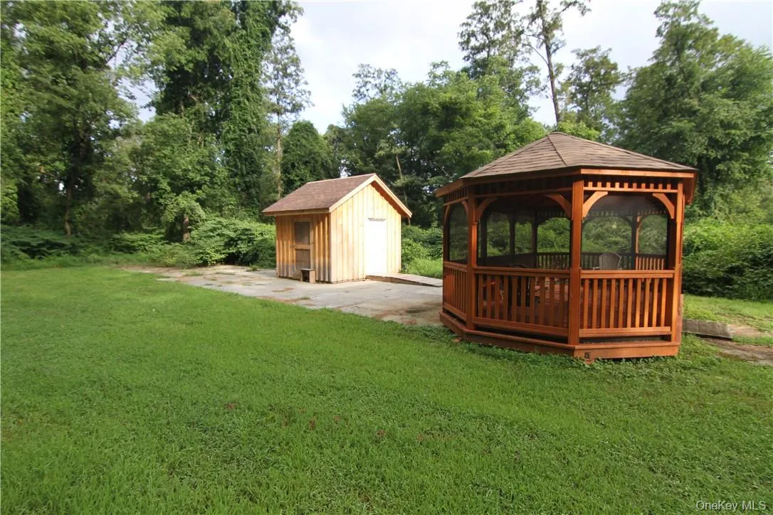 View of yard featuring a storage unit and a gazebo View of yard featuring a storage unit and a gazebo