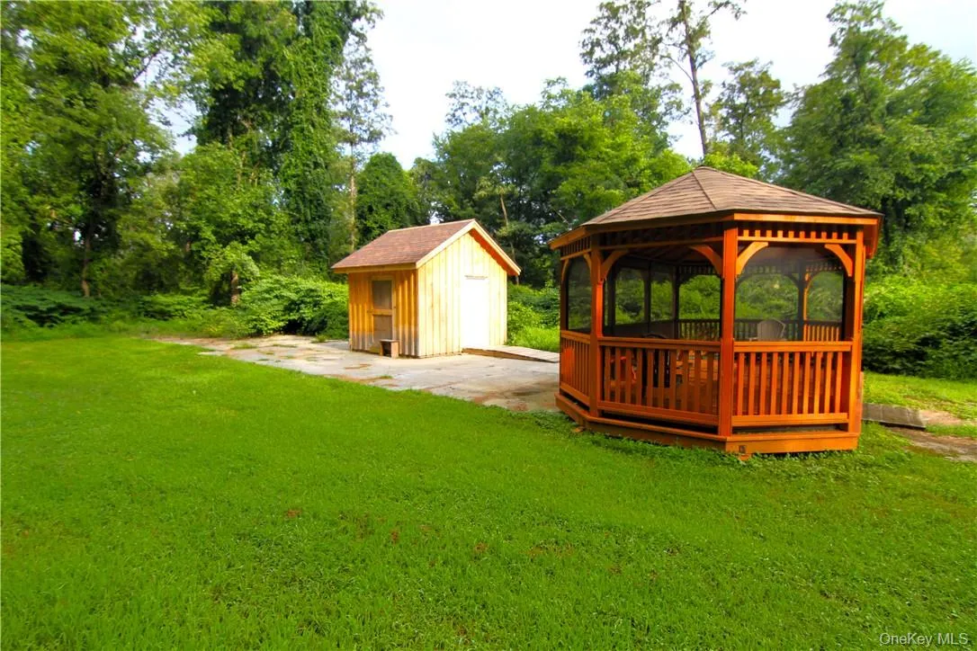 View of yard featuring a gazebo and a storage unit View of yard featuring a gazebo and a storage unit