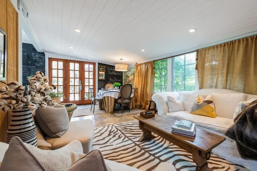 Tiled living room with wood ceiling, french doors, and vaulted ceiling Tiled living room with wood ceiling, french doors, and vaulted ceiling