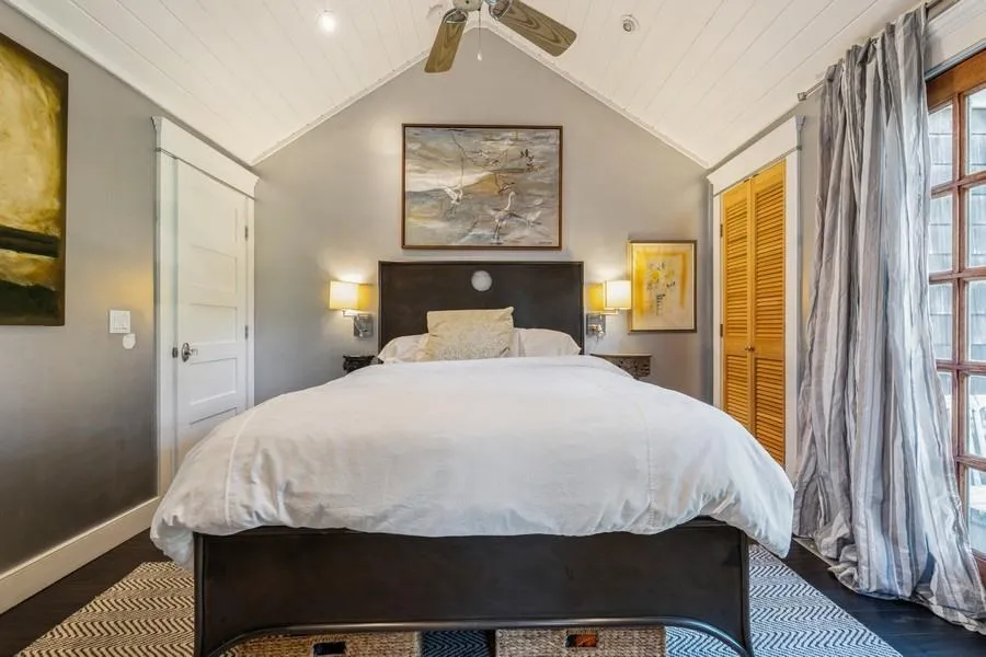 Bedroom with a closet, ceiling fan, lofted ceiling, and dark hardwood / wood-style floors Bedroom with a closet, ceiling fan, lofted ceiling, and dark hardwood / wood-style floors