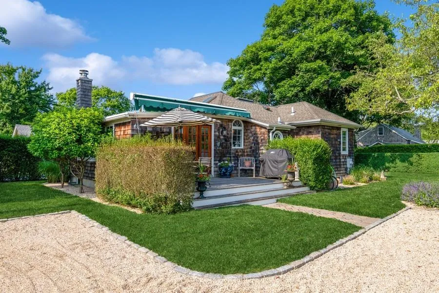 Back of property featuring a yard and a deck Back of property featuring a yard and a deck