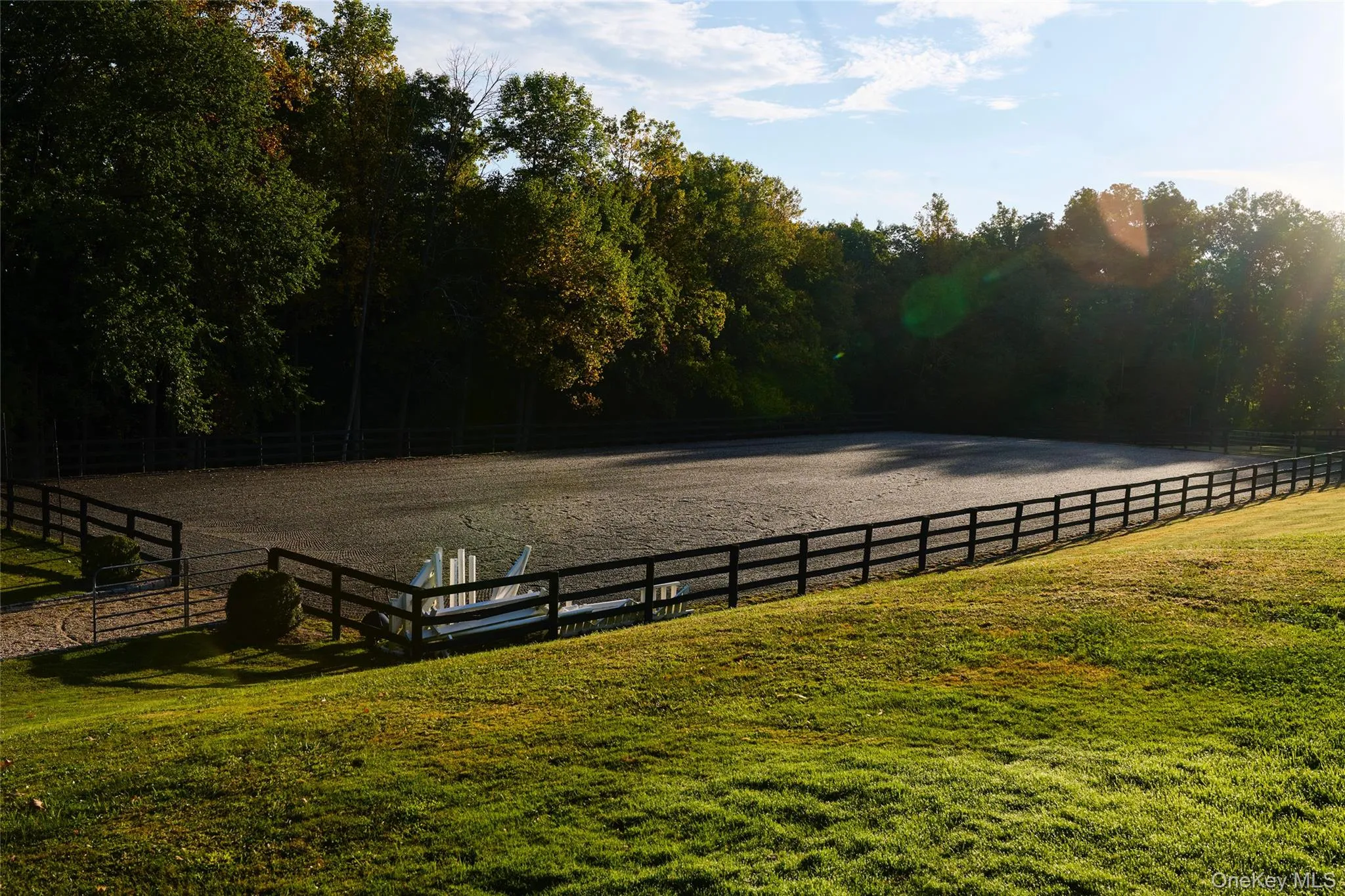 View of grassy yard with an enclosed riding area and a rural view View of grassy yard with an enclosed riding area and a rural view