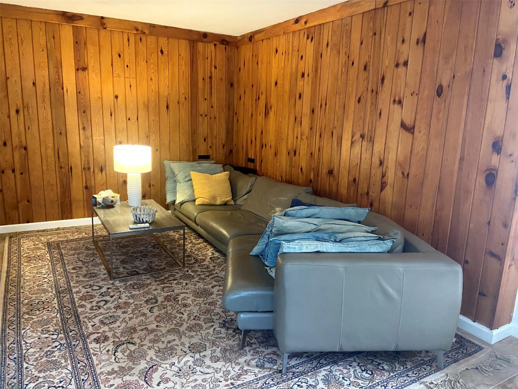 Sitting room with wood walls and baseboards Sitting room with wood walls and baseboards