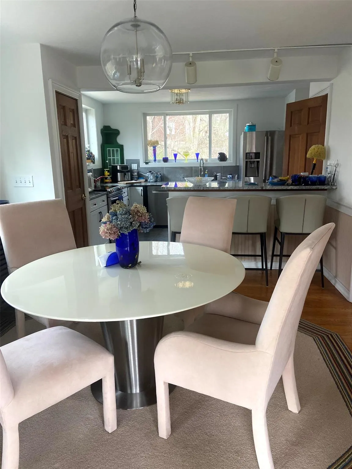 Dining space with a chandelier, wainscoting, and wood finished floors Dining space with a chandelier, wainscoting, and wood finished floors