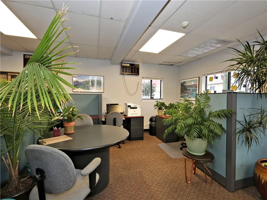 Carpeted home office with a wall mounted AC and a drop ceiling Carpeted home office with a wall mounted AC and a drop ceiling