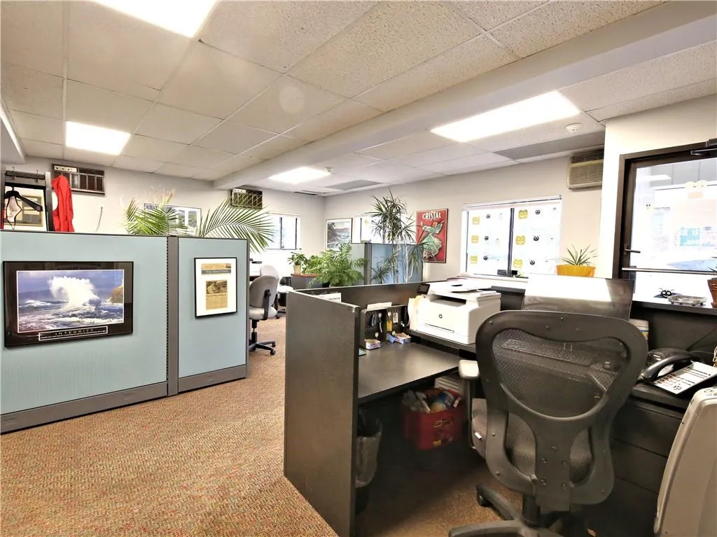 Carpeted office space featuring a drop ceiling Carpeted office space featuring a drop ceiling