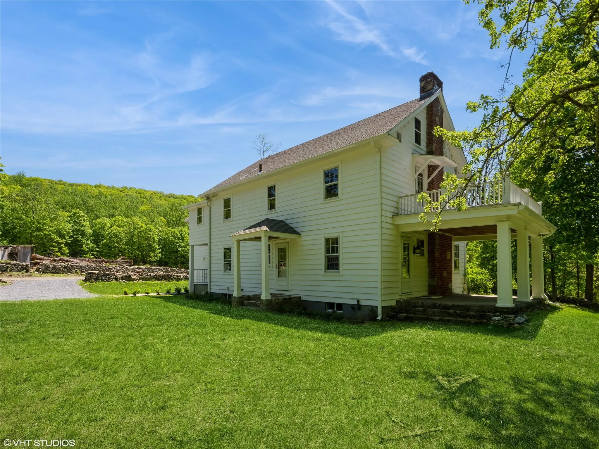 Back of house with a balcony, a chimney, a lawn, and a shingled roof Back of house with a balcony, a chimney, a lawn, and a shingled roof