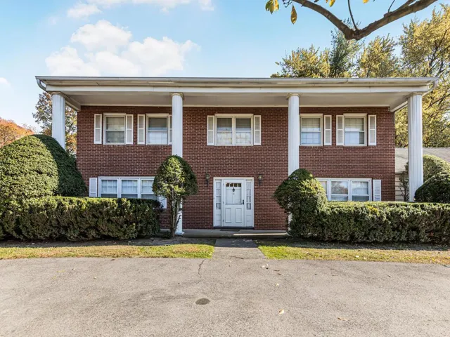 Beautiful Brick w White Columns & half moon driveway