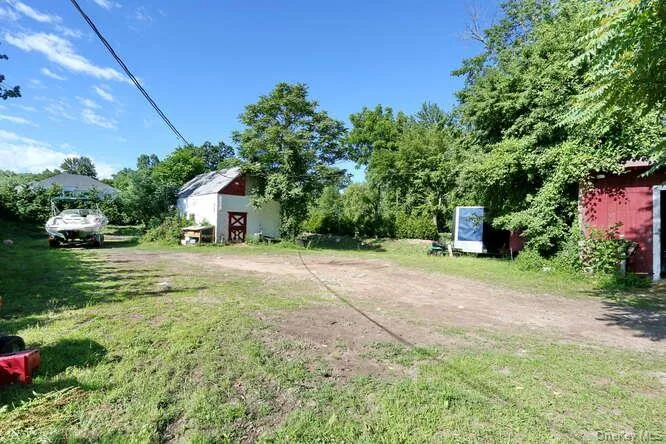 View of yard featuring a barn View of yard featuring a barn
