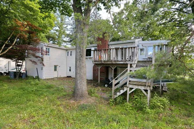 Rear view of house featuring a wooden deck Rear view of house featuring a wooden deck
