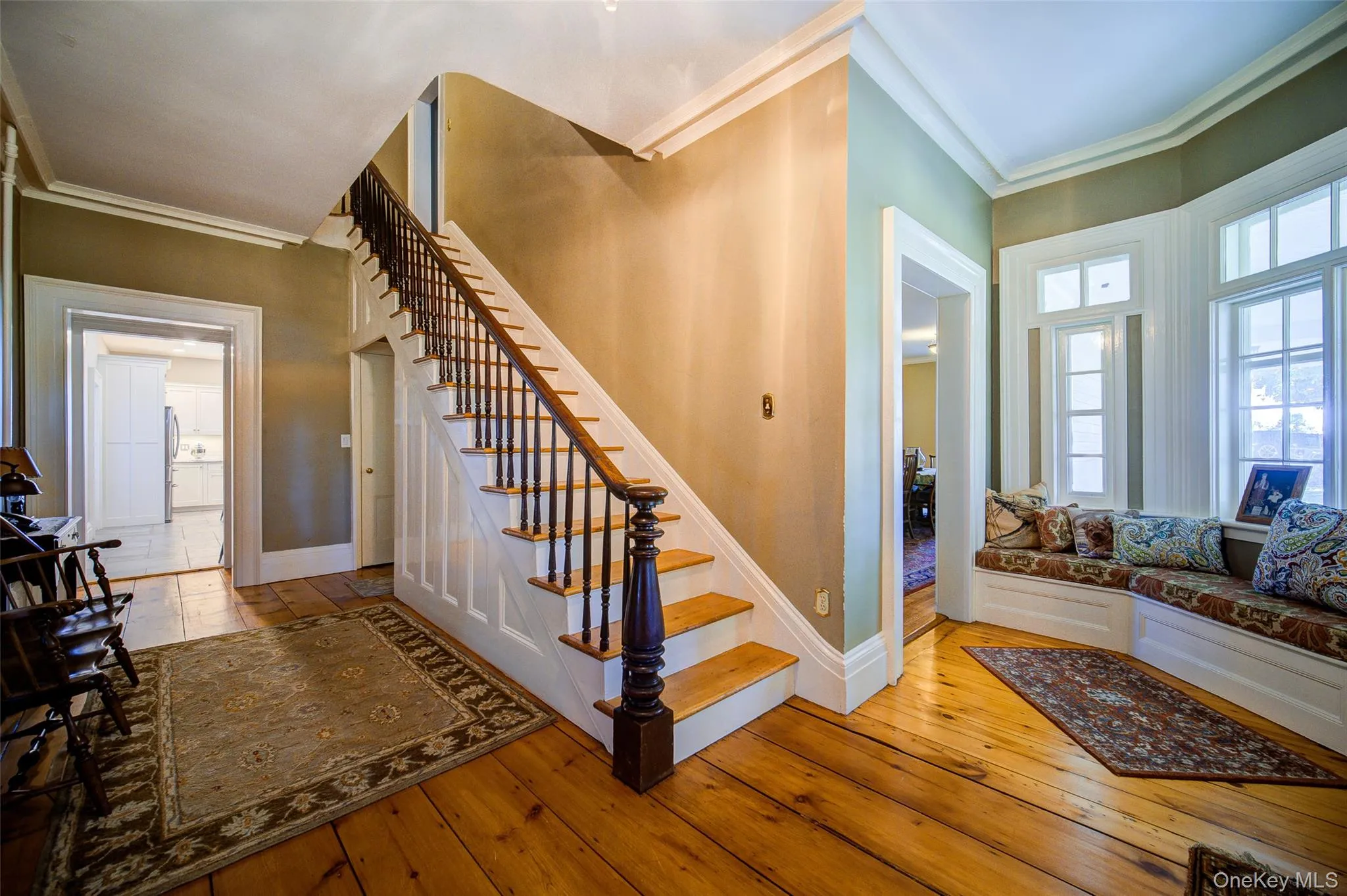 Stairway with crown molding and hardwood / wood-style flooring Stairway with crown molding and hardwood / wood-style flooring