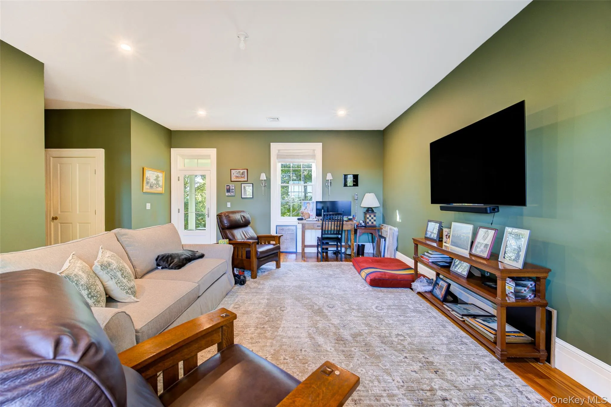Living room with wood finished floors, recessed lighting, and a desk Living room with wood finished floors, recessed lighting, and a desk