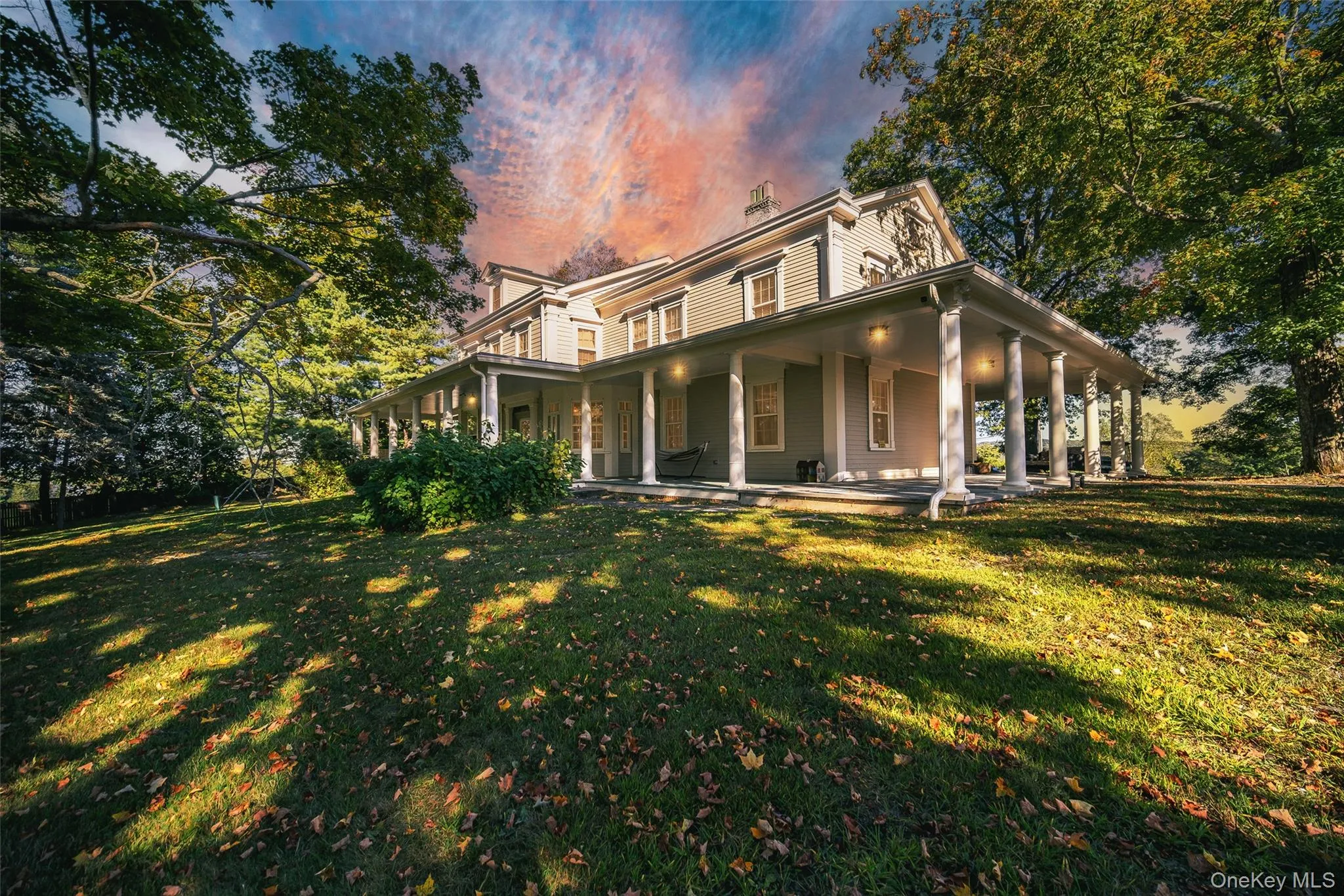 View of front of house featuring a porch, a chimney, and a front yard View of front of house featuring a porch, a chimney, and a front yard