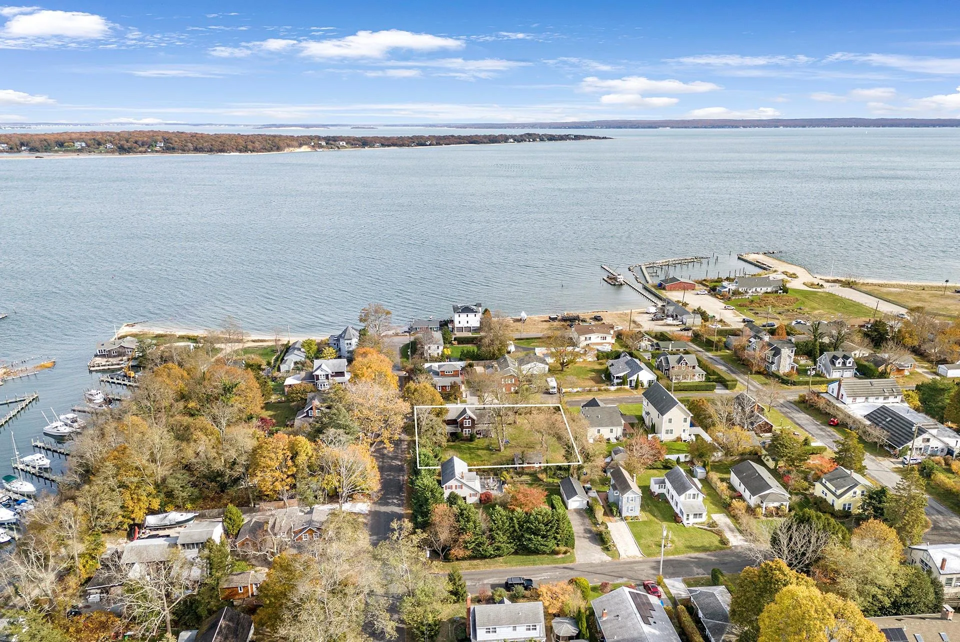 Aerial overview of property's location featuring a nearby body of water and nearby suburban area Aerial overview of property's location featuring a nearby body of water and nearby suburban area