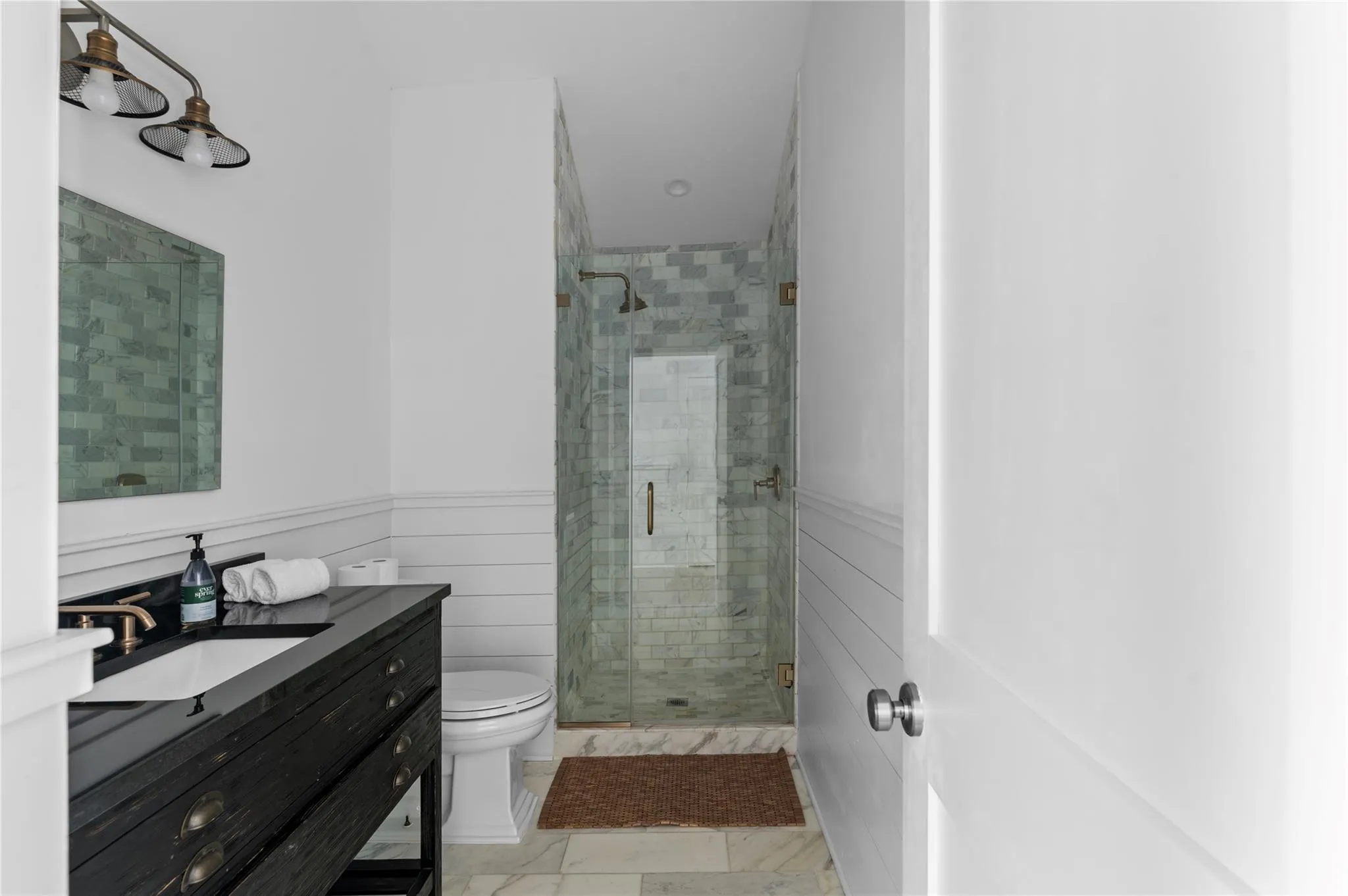 Bathroom featuring vanity, toilet, and a shower with door Bathroom featuring vanity, toilet, and a shower with door