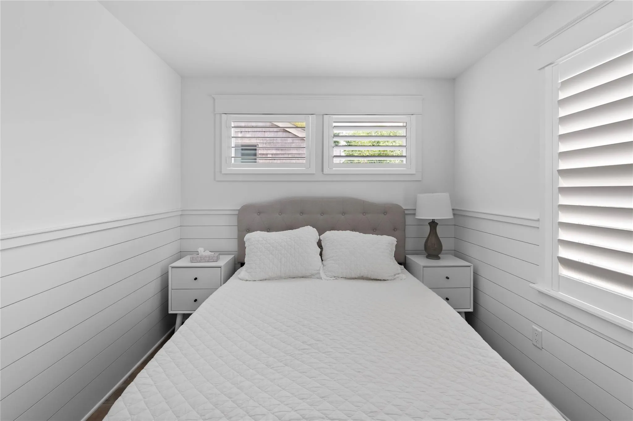 Bedroom featuring wooden walls Bedroom featuring wooden walls