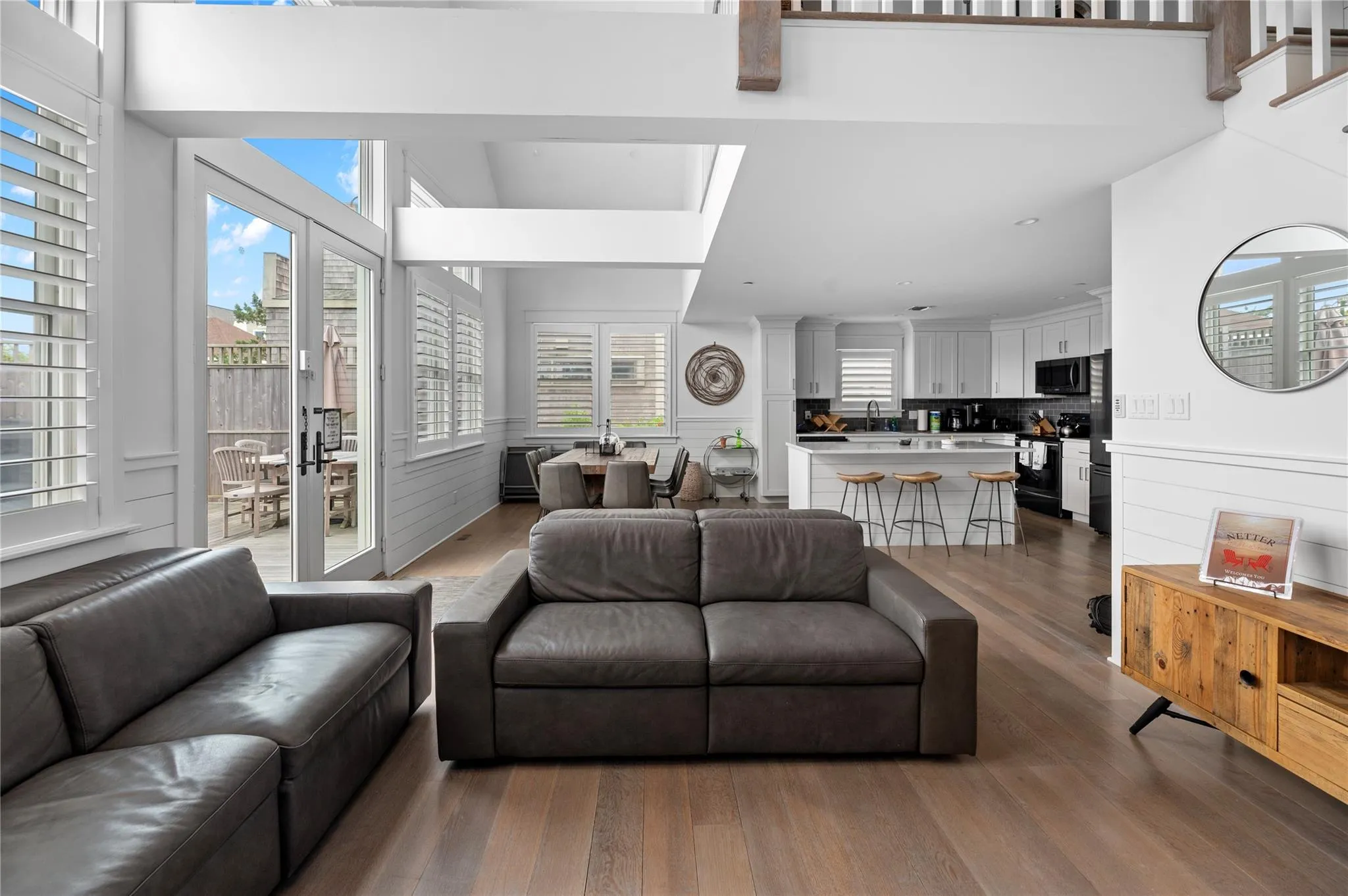 Living room with dark hardwood / wood-style flooring, sink, a towering ceiling, and french doors Living room with dark hardwood / wood-style flooring, sink, a towering ceiling, and french doors
