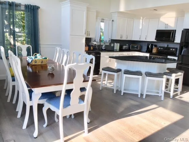 Dining room featuring hardwood / wood-style flooring Dining room featuring hardwood / wood-style flooring