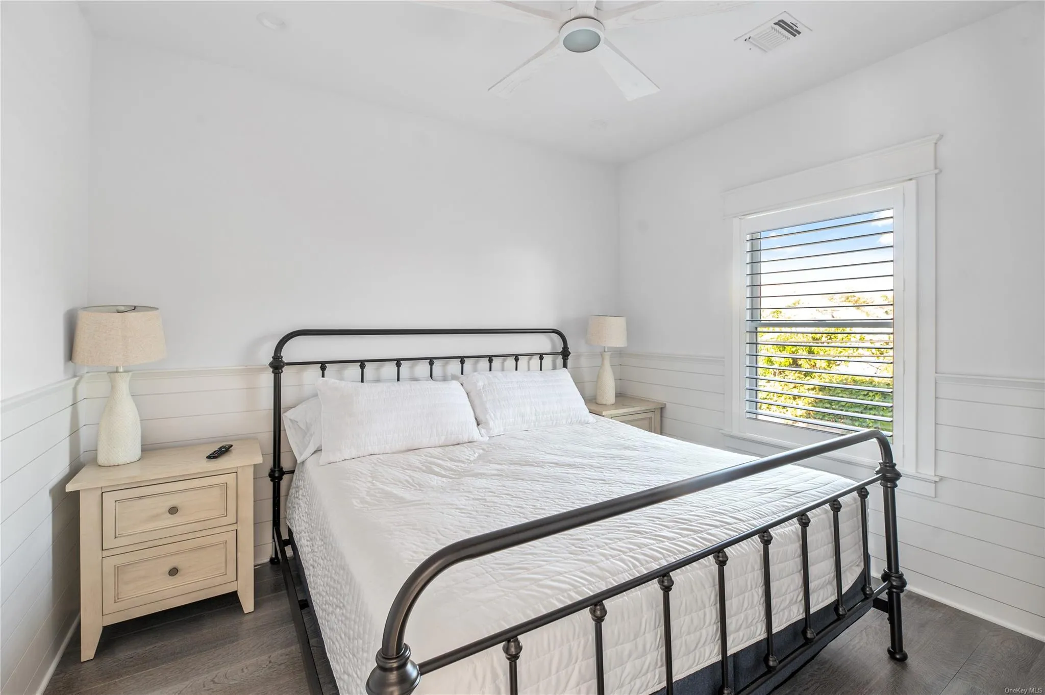 Bedroom featuring ceiling fan and dark hardwood / wood-style floors Bedroom featuring ceiling fan and dark hardwood / wood-style floors