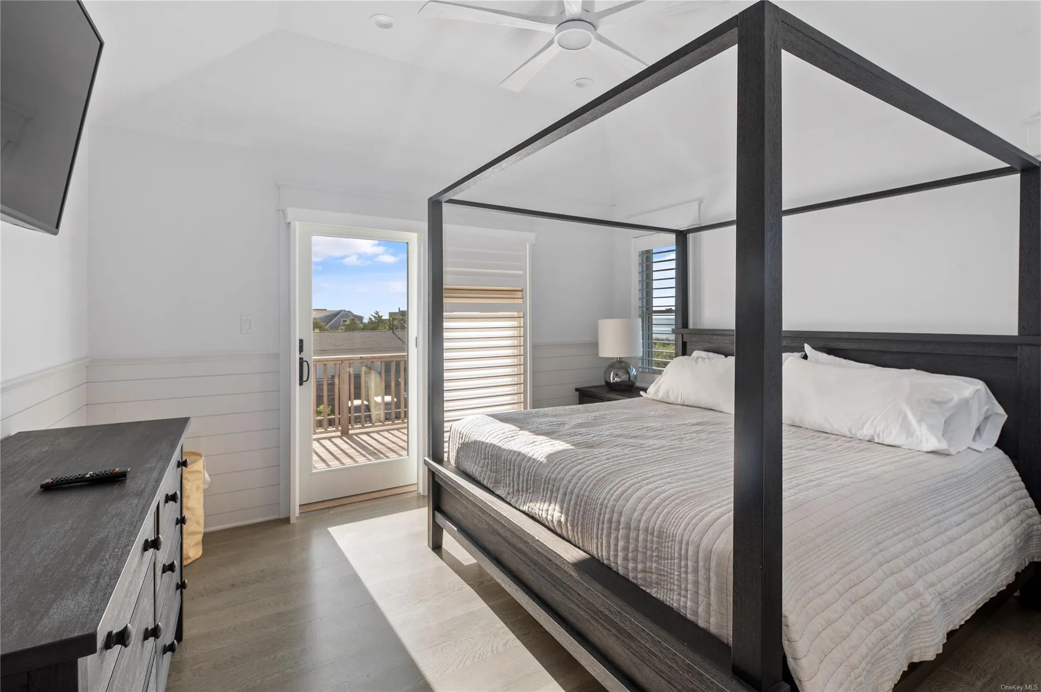 Bedroom with multiple windows, hardwood / wood-style floors, access to exterior, and ceiling fan Bedroom with multiple windows, hardwood / wood-style floors, access to exterior, and ceiling fan